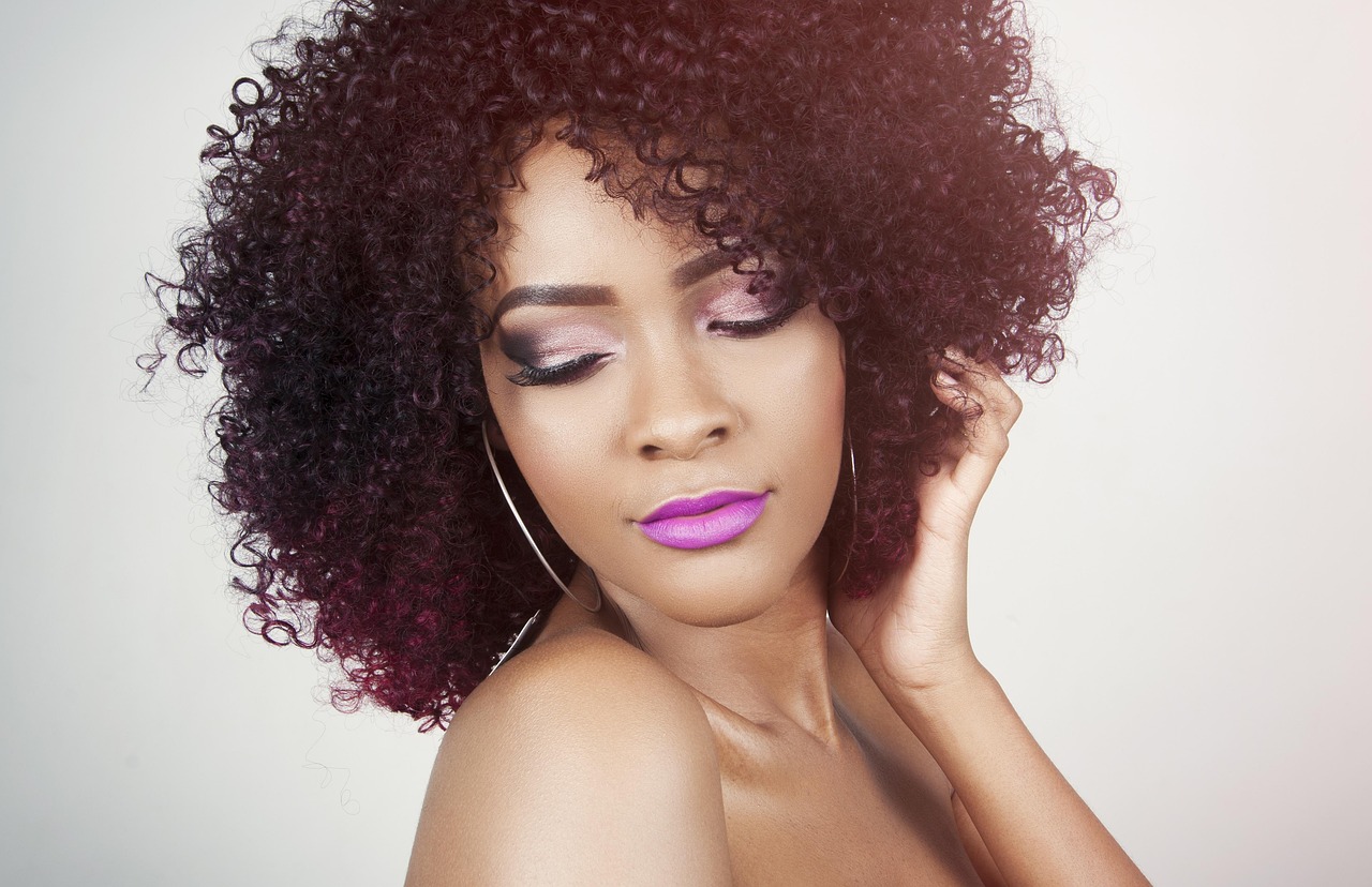 Portrait of a woman with curly hair and finished makeup