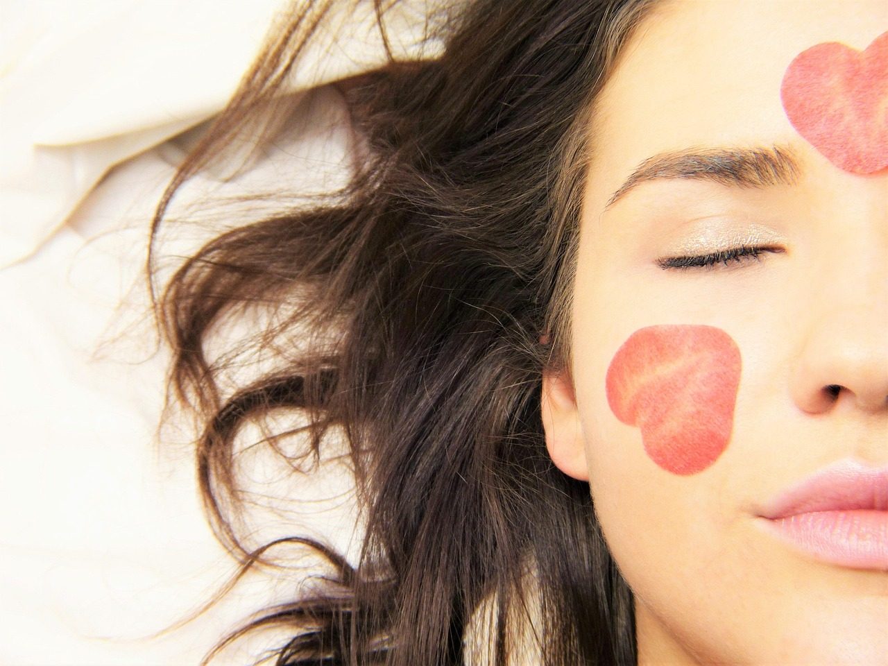 Woman resting with eyes closed during a skincare treatment